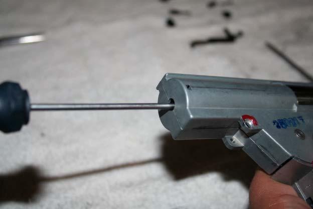 Slide a small screwdriver into the back of the mechbox and push down to take up the spring tension.