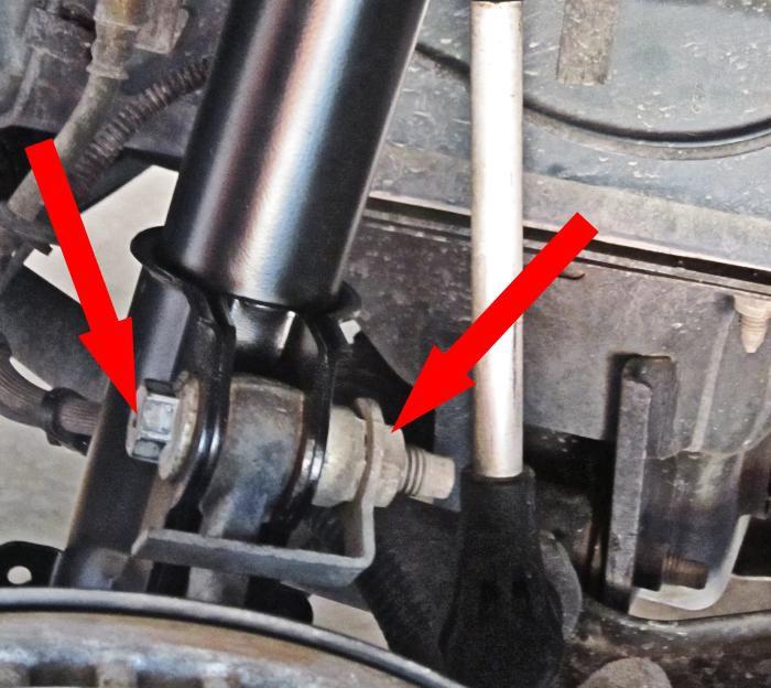 Slide both strut-to-spindle bolts through the lower strut clevis and spindle (left picture below). 31.