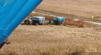 Pivoting vertical auger allows lows