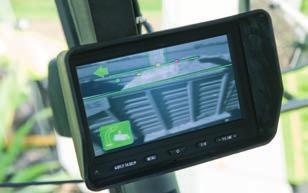 Additionally, the system is able to determine where the harvested crop will impact as it enters the trailer.