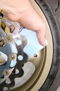 21. Using brake or contact cleaner and a rag, clean both sides of the rotors to insure that you