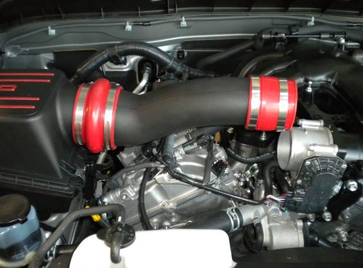 Slide the throttle body coupler onto the end of the TRD inlet pipe with a #52, and a #56 hose clamp. (Fig.