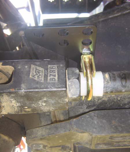 Use the small muffler clamp to attach the linkage rod bracket to the steering cylinder. See Figure 4-4.