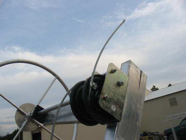 Put free end of cable thru hole in side of winch below the clamp push cable thru one side of the clamp, make a large loop then push cable back thru the other side of the clamp.