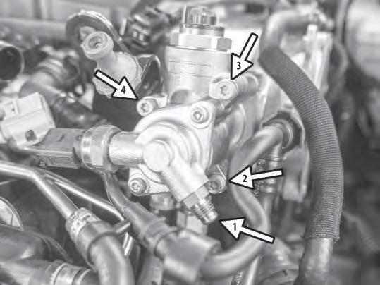23) Then remove the three T30 bolts from the fuel pump, but leave the two lower fuel lines connected.