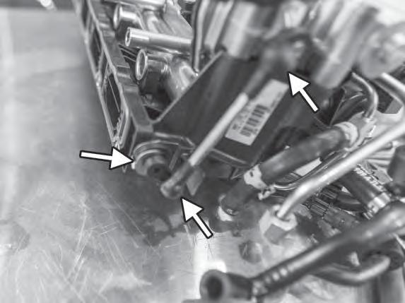 28) On the left side of the intake manifold, disconnect the metal clip from the runner flap lever.