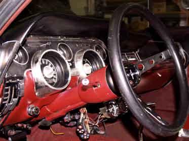 Remove the nut and use a wheel puller to pull the original steering wheel off the original column.
