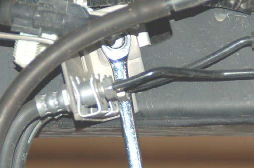Using a 10mm wrench, remove the brake line