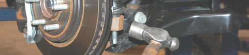 Remove tie-rod end using a 21mm wrench.