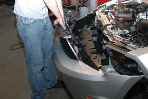With the front fascia pulled forward a few inches, remove the fog light electrical connectors by