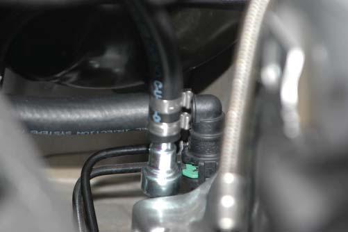 81. Connect the fi tting with the green locking tab to the driver side hose barb below the brake booster canister from