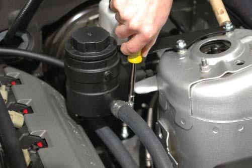 If you placed a cap on the existing fuel line below the brake booster canister, remove it and attach the provided fuel