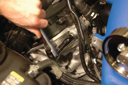 Route the extension harness under the supercharger inlet to the driver side and pull out toward the inlet.