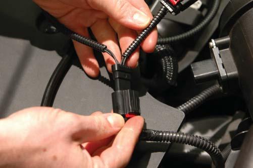Press the supplied PCV hose barb and brake booster hose barb into the holes on the inside curve of the