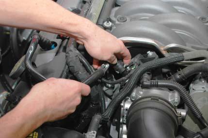 5. Remove the decorative engine cover by carefully