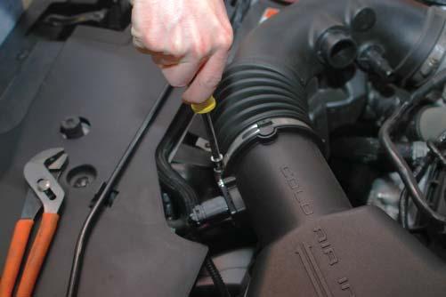 Use the provided plug to seal the resonator hole in the fi rewall, below the brake booster and