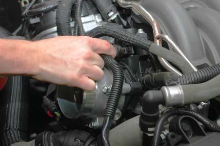 13. Use the provided fuel line removal tool to remove the fuel line from the supply barb below the Brake