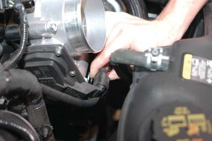 17. Use a 10mm wrench to remove the brake booster vacuum line from the