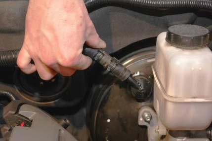 Use a 10mm wrench to remove the heater hose mounting channel on the