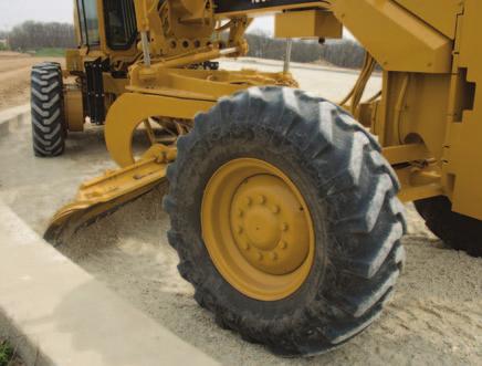 Use the motor grader to finish near the curb line where rear wheels are kept on a smooth surface, the moldboard near a 30 degree angle, and the drawbar centered under the frame.