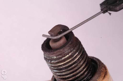 2. Periodic Maintenance > Spark Plug XCITING 400i Remove the spark plug with a spark plug with a 5/8 in socket.
