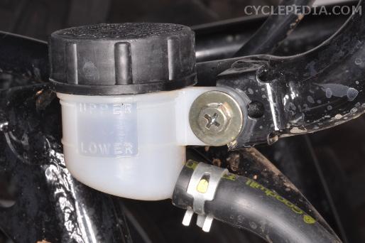 Inspect the brake fluid level in the reservoir. The level should be above the lower line.