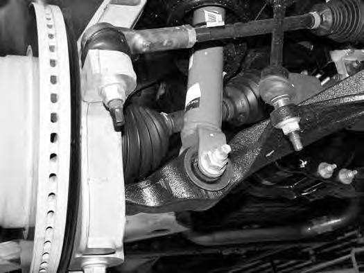 Reinstall the nuts a few turns by hand. Separate the upper and lower ball joints from the steering knuckle using the appropriate puller. Take care not to damage the ball joint. 26.