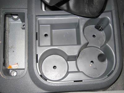 There are 3 screws under the cup holders to remove