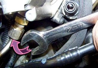 Step 7 Use a 17mm open end or flange nut wrench to loosen the fuel line attachment collar.