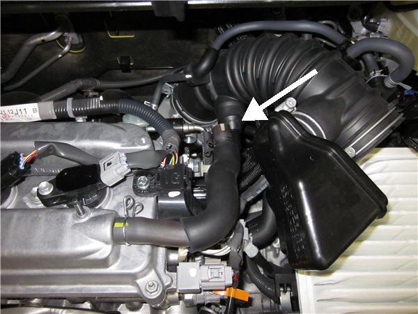 Unclip the vacuum hose from the rubber inlet hose near the throttle body and retain for later