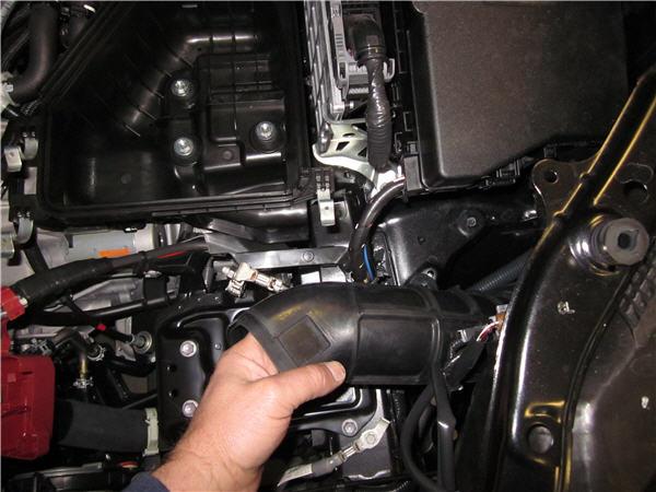 D. Install TRD Air Intake 1. Lower the TRD air box inlet tube into position behind the headlight as shown. (Fig. D 1) 2.