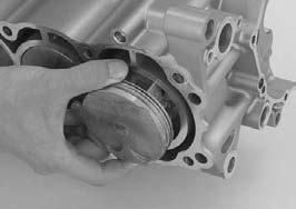 Do not try to remove the piston/connecting rod assembly from bottom of the cylinder; the assembly will get stuck in the gap between the cylinder liner and the upper crankcase.