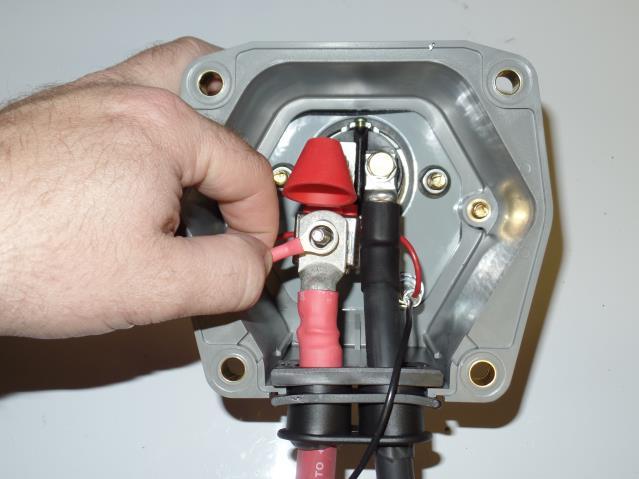 Use a 7/16 inch socket or nut driver to tighten this connection. STEP 6 Slide the 2/0 red positive cable through the black rubber grommet located at the bottom of the Dual Pole box.