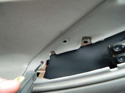STEP 4: Using a Phillips head screw driver, remove the interior door trim retaining screw.