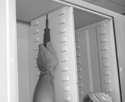 Using one of the self drilling screws that have been provided, secure the top of the wardrobe panel to the rotor top through the clearance hole in the top