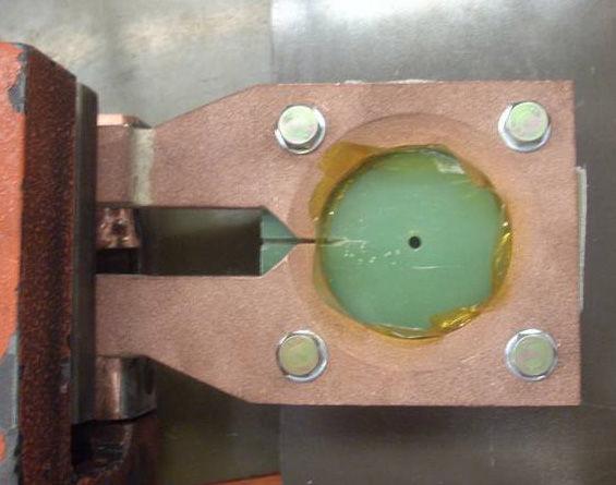 Figure 3: Partial section view of the circular hemming set-up with the % of flange height as input variable (left) and one of the hemming coils (right).