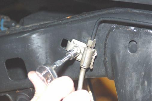 12. Remove the bolts securing the upper control arms to the axle using a 18mm wrench/socket.