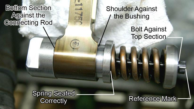 6. Make sure: The bottom section of the tool is in contact with the connecting rod The shoulder of the center section of the tool is in contact with the