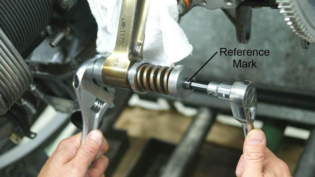 Use a wrench to hold the bottom section of ST-531 and turn the bolt with the ratchet and 1/4-inch Allen socket clockwise six full turns (Figure 9).