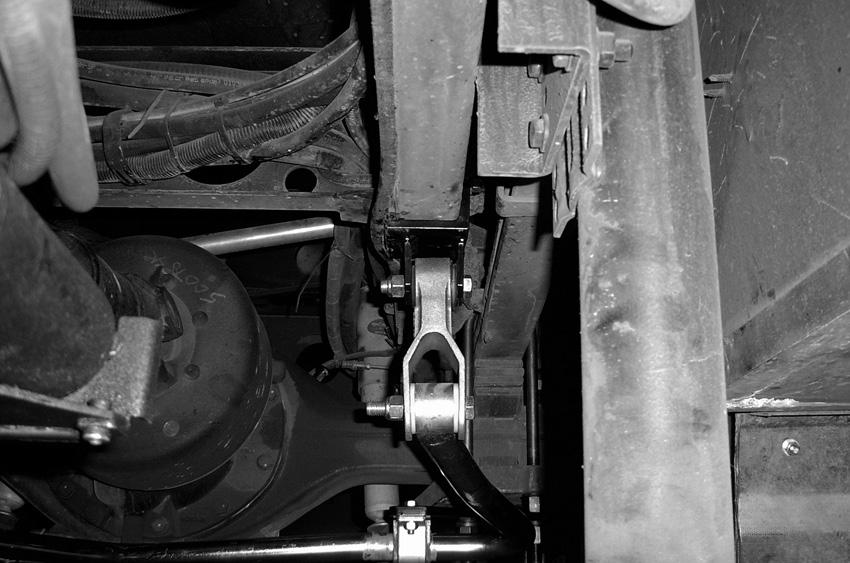 With this configuration, the bracket will mount under the axle plate and above the shock plate and facing the rear of the coach (Figure 10). 11.