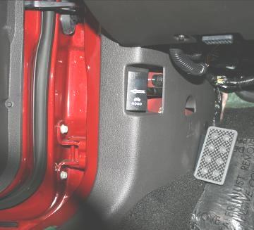 50 Re-install the driver side (LH) kick panel trim and fasten with