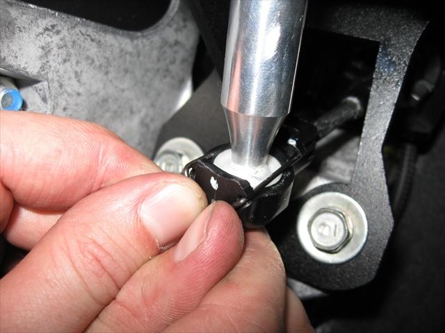 24. Clip the passenger side shifter cable back on the TWM short shifter as pictured to the
