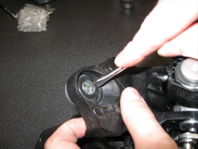 First, push the metal sleeve out of the rubber grommet with your finger, then remove the rubber grommet by pushing it