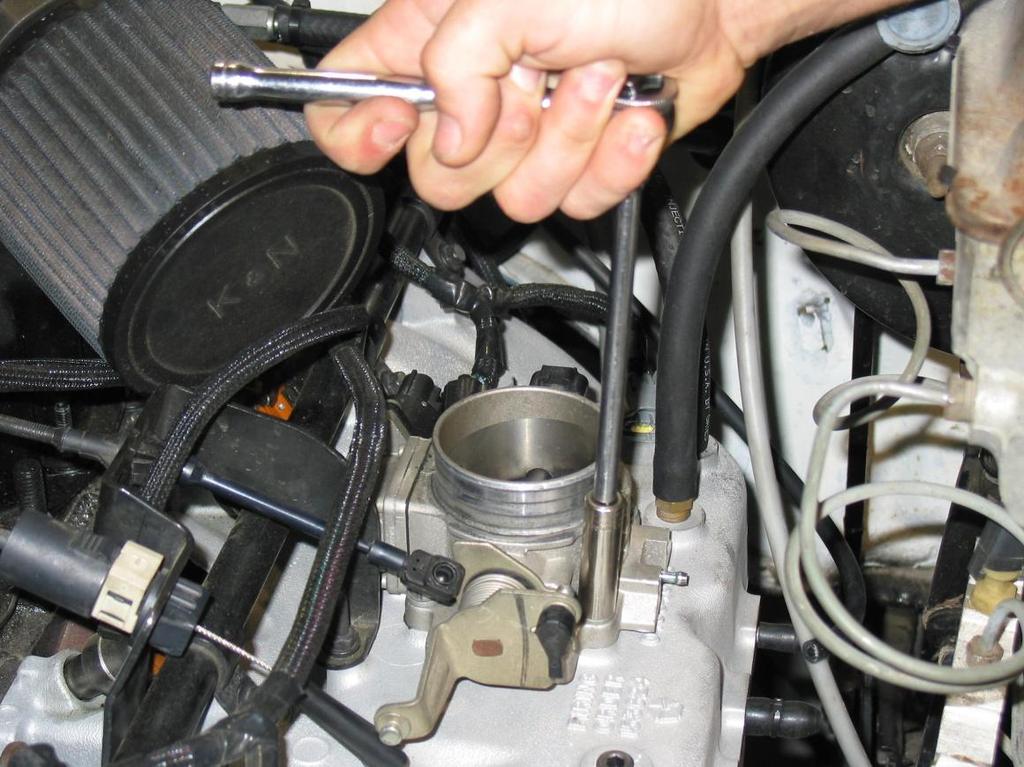 3.4 Using a 10mm socket on a 6 extension, remove the four(4) throttle body mounting bolts and remove the