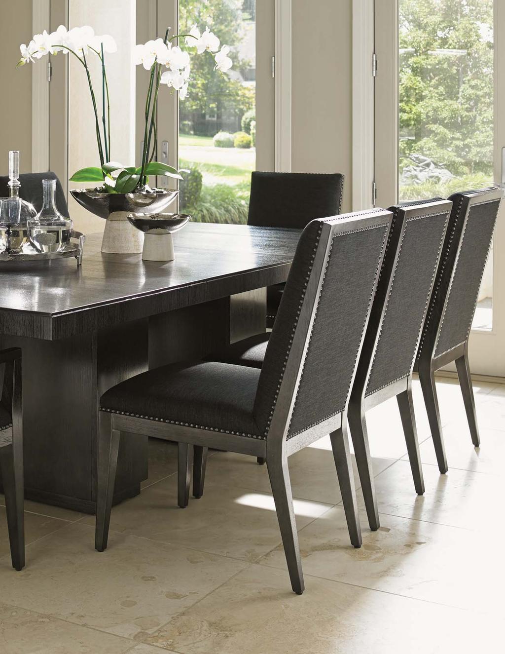 The Gray Mist fabric on the chairs features a soft linen weave, framed with nailhead trim for an elegant tailored look.