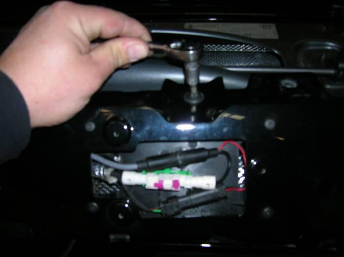 Disconnect the ground and the two wiring harness connectors for the reverse camera.