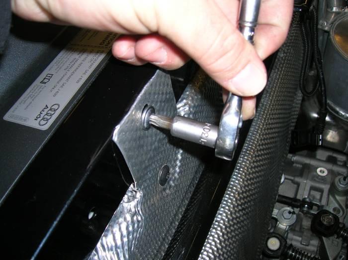 Using a T-30 torx, remove the 2 fasteners