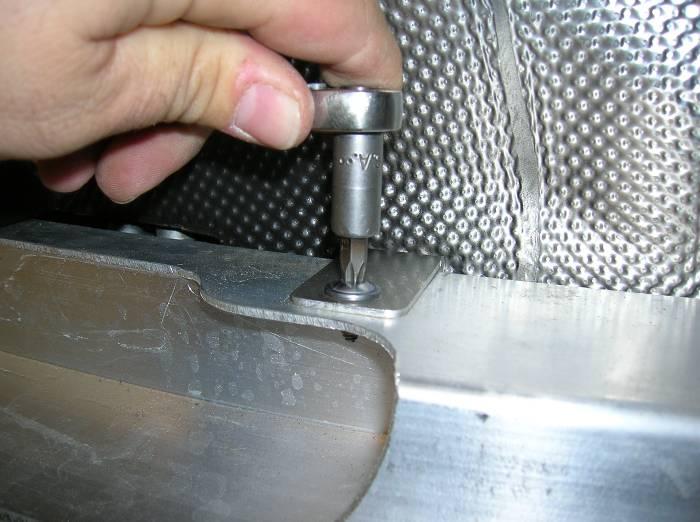 Using a T-30 torx, remove the 3 fasteners securing the heat shield