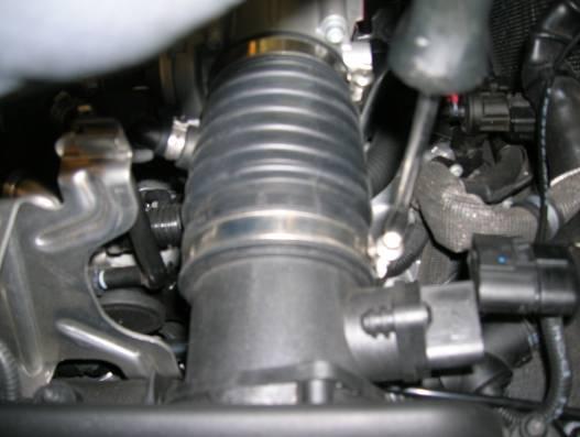 Install power steering reservoir cap to prevent contamination. Repeat on passenger side.