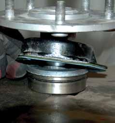 Install the bearing spacer over the axle and install new bearings and lock ring, making